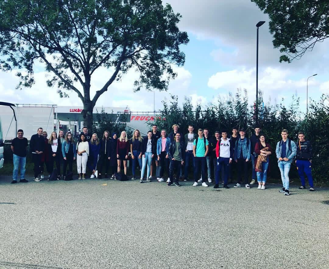 Group of students celebrating passing their theory exam together